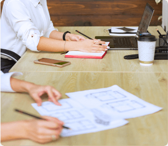 Two people working on an office table